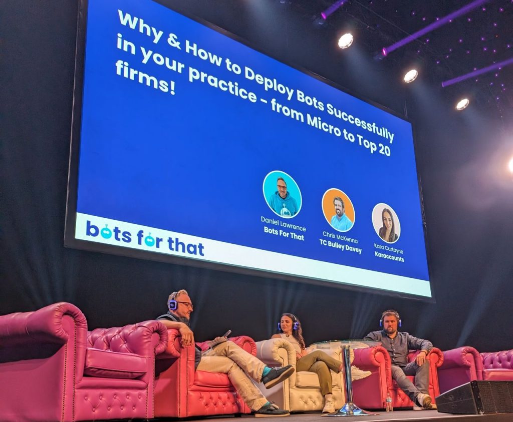 DAS. Main stage talk last year. Image of a stage with a presentation and people sitting on chairs talking