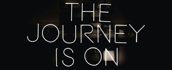 Implementing AI. A neon sign that reads, 'the journey is on'