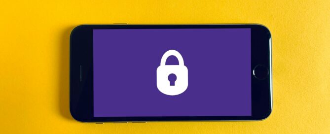 Governance and security - a phone laid on a yellow background, the phone screen is purple with a white padlock