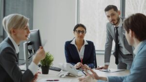 large firms. A group of accountants conversing at a desk