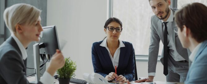 large firms. A group of accountants conversing at a desk